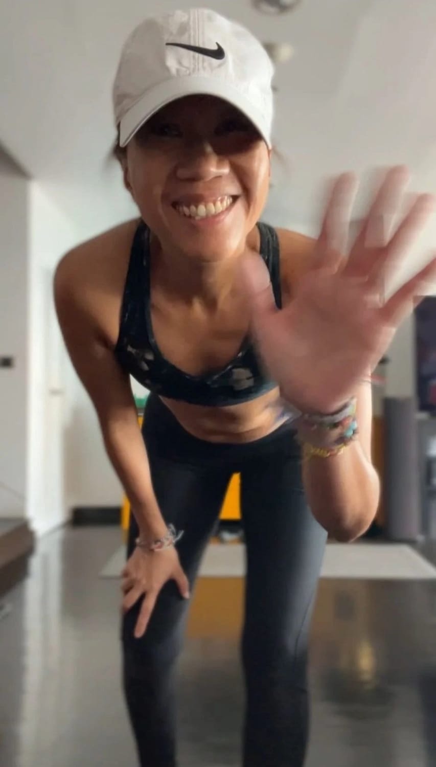 Tatch, creator of the Reverse ME Method, waving hello in workout gear